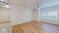 Located at 803 Holliday Dr in Greensboro, NC, this single-floor residence offers a thoughtfully designed layout with one bedroom, one bathroom, a kitchen, hallway, and dedicated closet space. Warm, light-toned hardwood-style flooring flows consistently throughout, lending a cohesive and inviting feel to the entire unit.

The kitchen is a standout feature, showcasing white shaker cabinetry with matte black hardware, granite countertops, a subway tile backsplash, and stainless steel appliances including a range, microwave, and side-by-side refrigerator. A central island with a built-in sink and pendant lighting above serves as both a functional workspace and a visual focal point. A charming sliding barn door adds a rustic touch to the otherwise contemporary aesthetic.

The bedroom is a comfortable, well-lit space featuring a ceiling fan, a large window with blinds that invites natural light, and clean white walls. It connects directly to a spacious walk-in closet equipped with built-in shelving and hanging rods, providing ample storage.

The bathroom is designed with accessibility in mind, featuring multiple stainless steel grab bars throughout, a full soaking tub with shower, granite-topped vanity, and matching flooring. The result is a clean, safe, and functional space. Overall, the residence presents a modern, move-in-ready environment with practical amenities.