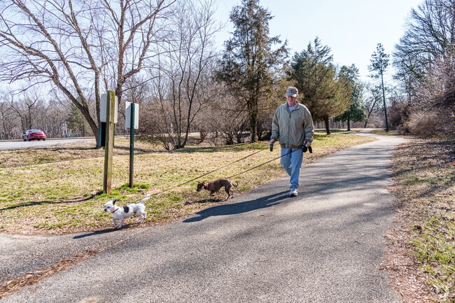 A couple of local residents of Claymont and their two-legged friend walk through Woods Haven Kruse Park.