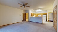 Located at 2000 Windsor Ct in Plover, Wisconsin, this single-floor unit offers a practical and comfortable layout designed for everyday living. The open-concept living area features soft carpeting, warm neutral walls, and a ceiling fan overhead, creating a welcoming atmosphere. A sliding glass door floods the space with natural light and provides direct access to the outdoors, with views of the surrounding greenery.

The kitchen is well-appointed with an abundance of warm oak cabinetry, generous counter space, a double stainless steel sink, and a full suite of white appliances including a refrigerator, electric range, microwave, and dishwasher. Light tile flooring runs throughout the kitchen, which connects seamlessly to the living area via a peninsula-style counter.

The bedrooms are carpeted and bright, each featuring windows that bring in natural light and ample wall space for furnishings. The bathroom is finished with light tile flooring, an oak vanity, and a full tub/shower combination. A dedicated in-unit laundry closet with a stacked washer and dryer adds a convenient and practical touch. Throughout the unit, six-panel oak doors and wood baseboards contribute a consistent, clean aesthetic.