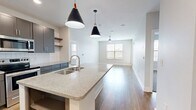 This contemporary 900 square foot apartment in Little Rock, Arkansas, offers a thoughtfully designed living space with two bedrooms and two bathrooms. The open-concept floor plan seamlessly integrates the kitchen, living, and dining areas, creating a spacious feel. The gourmet kitchen is a standout feature, boasting sleek gray cabinetry, stainless steel appliances, and a large center island with a granite countertop, perfect for casual dining or entertaining.

Throughout the apartment, hardwood floors add warmth and elegance, while large windows allow ample natural light to flood the space. The primary bedroom, measuring 130 square feet, provides a generous retreat with plush carpeting and an en-suite bathroom. The second bedroom also features carpeting and offers versatility as a guest room or home office.

Both bathrooms are modern and well-appointed, with granite countertops, ample storage, and stylish fixtures. The apartment includes two closets for additional storage. Energy-efficient features such as ceiling fans and modern HVAC systems ensure year-round comfort. Located at 701 Rahling Rd, this apartment combines contemporary design with practical living in a desirable Little Rock neighborhood.