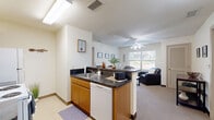 This 670 square foot apartment in Youngstown, Ohio, offers a well-designed living space with two bedrooms and two bathrooms. The functional kitchen features white appliances, including a microwave and electric stove, complemented by honey-toned wooden cabinets and dark countertops. A small pantry area adds extra storage.

The bedrooms are bright and airy, with large windows allowing natural light to flood in. Each room is equipped with a ceiling fan and ample closet space. The primary bedroom, measuring 130 square feet, provides a comfortable retreat.

The bathrooms are clean and modern, featuring a shower-tub combination with a curved shower rod and geometric patterned shower curtain. Dark countertops contrast nicely with the light-colored fixtures.

Throughout the apartment, neutral tones dominate, creating a calm and versatile living environment. The layout is efficient, maximizing the use of space in every room. Closets with wire shelving systems offer additional storage solutions.

This compact urban dwelling is ideal for those seeking a low-maintenance lifestyle in a convenient location. Its thoughtful design and practical amenities make it a perfect choice for singles, couples, or small families looking for a cozy home in the heart of Youngstown.