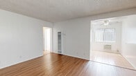 Located at 11942 Old River School Rd in Downey, CA, this single-floor, 2-bedroom, 1-bathroom unit offers a clean and functional layout designed to maximize comfortable living. The living room is bright and open, featuring warm wood-look laminate flooring, a textured ceiling, vertical blind-covered windows and sliding door that invite natural light, and a wall-mounted heater unit. The space flows seamlessly into the rest of the home via a central hallway. The kitchen is efficiently designed with white cabinetry, a tile backsplash, a gas range, a double basin sink, and light tile flooring — providing ample storage and counter space. Both bedrooms are carpeted and feature ceiling fans with lighting, vertical-blind windows, and a textured ceiling, offering a comfortable and quiet retreat. The spacious primary bedroom provides generous room for furnishings. The full bathroom is finished in light tile flooring, and includes a tub-shower combination, a white vanity with storage, and a window for natural ventilation. With four closets distributed throughout, storage is abundant. The unit's neutral white walls and consistent finishes create a clean, move-in-ready ambiance throughout.