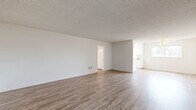 Located at 3553 Emerald St in Torrance, CA, this single-story, 3-bedroom, 2-bathroom home offers a practical and well-organized layout across its single floor. The spacious living room serves as the heart of the home, featuring light wood-style flooring, neutral white walls, a textured ceiling, and a ceiling fan, creating a bright and airy atmosphere. Natural light flows in through windows fitted with vertical blinds, enhancing the open feel of the main living area.

The galley-style kitchen is efficiently designed with ample white cabinetry on both sides, white appliances including a range, a double sink, and light wood-style flooring, making it both functional and clean in appearance.

All three bedrooms are finished with plush carpeting, providing comfort underfoot. Each bedroom includes a sliding-door closet with built-in shelving, and windows that allow for natural light. The primary bedroom offers a generous footprint with ample closet space.

The two bathrooms are finished with wood-style flooring and white vanities featuring stone-look countertops. The full bathroom includes a tub-shower combo with sliding glass doors and a well-lit mirror vanity, while the second bathroom offers a streamlined vanity and toilet. A connecting hallway ties all rooms together cohesively.