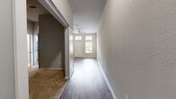 Located at 2750 Dade Ave in Orlando, FL, this one-bedroom, one-bathroom unit offers a well-designed single-floor layout that makes efficient use of its intimate footprint. The living area greets you with rich wood-look plank flooring, neutral-toned walls, and a front entry door flanked by large windows and transom panels that draw in generous natural light. A ceiling fan adds both comfort and a functional touch to the space. The hallway, lined with sliding-door closets for additional storage, connects the living area to the rest of the unit. The kitchen is outfitted with stainless steel appliances — including a refrigerator, range, and over-the-range microwave — complemented by light wood cabinetry, granite-look countertops, and a classic subway tile backsplash, all set atop durable wood-look flooring. The bedroom offers plush carpeting, soft gray walls, and direct access to a dedicated walk-in closet with built-in shelving — providing ample organization space. The bathroom is clean and functional, featuring tile flooring, a full soaking tub with shower, and a light wood vanity. This unit blends practicality with modern finishes throughout.
