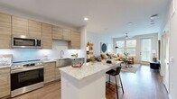 Located in Cypress, TX, this thoughtfully designed one-bedroom, one-bathroom residence offers a comfortable and modern living experience across a single floor. The open-concept layout seamlessly connects the kitchen and living room, creating an inviting, airy atmosphere ideal for both everyday living and entertaining.

The kitchen is a standout feature, showcasing light wood cabinetry, a granite-topped island with bar seating, a white subway tile backsplash, and a full suite of stainless steel appliances, including a French door refrigerator, microwave, and range. The living room receives abundant natural light through large windows and a glass door, and is equipped with a ceiling fan for added comfort. Warm wood-look flooring flows continuously throughout the space.

The bedroom is generously sized, featuring multiple windows, a ceiling fan, and access to a walk-in closet with built-in shelving and hanging rods. The bathroom offers a dark-vanity with a quartz countertop and stylish geometric tile accents. A dedicated laundry area with full-size washer and dryer hookups adds convenience. A hallway connects the private areas of the home, completing this well-organized and functional floor plan.
