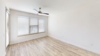 Located at 5001 White Settlement Rd in Fort Worth, TX, this one-bedroom, one-bathroom residence offers a thoughtfully designed single-floor layout with modern finishes throughout. The combined kitchen and living area serves as the heart of the home, featuring light wood-look flooring, a ceiling fan, and a large window dressed with horizontal blinds that allows ample natural light. A glass-panel exterior door provides access to the outdoors and further brightens the living space.

The kitchen is equipped with dark espresso cabinetry, light stone countertops, a full suite of stainless steel appliances including a French door refrigerator, electric range, built-in microwave, and a beverage cooler. Track lighting overhead highlights the clean, contemporary design.

The bedroom is carpeted for comfort and includes a ceiling fan, a generously sized window with outdoor views, and direct access to the bathroom. The bathroom features wood-look tile flooring, dark vanity cabinetry with a light countertop, a framed mirror, and a tub-shower combination with floor-to-ceiling dark tile surround. A dedicated closet completes the private quarters.

The entryway is bright and welcoming, with clean white walls and warm-toned flooring that flows consistently throughout the main living areas.