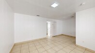 Located at 2070 NE 162nd St in North Miami Beach, FL, this one-bedroom, one-bathroom unit offers a practical and efficiently designed single-floor layout. Light beige ceramic tile flooring runs consistently throughout the entire space, lending a cohesive and easy-to-maintain feel.

The open living, dining, and kitchen area forms the heart of the unit. The living and dining space is bright and airy, illuminated by a flush skylight-style ceiling fixture that enhances the clean, white walls. A louvered closet door provides convenient storage access directly from this main area.

The galley-style kitchen is thoughtfully appointed with white cabinetry, granite-look countertops, a stainless steel refrigerator, and a stainless steel range. A window above the counter allows natural light to filter in, making the space feel open despite its compact footprint.

The bedroom is a well-proportioned, quiet retreat featuring a window with blinds that brings in additional natural light. Its straightforward layout offers flexibility for various furniture arrangements.

The full bathroom is finished in a clean, all-white palette, complete with a vanity with cabinet storage, a wall-mounted mirror with overhead lighting, a toilet, and a shower/tub combo. The consistent tile flooring ties the bathroom seamlessly to the rest of the unit.

Overall, this unit presents a clean, functional, and well-maintained living space in a convenient North Miami Beach location.