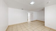 This 530 square foot apartment, located in North Miami Beach, offers a practical and efficient living space. The single-floor layout comprises one bedroom, one bathroom, a kitchen, and a closet, making it an ideal choice for individuals or couples seeking a low-maintenance home.

The interior is characterized by its bright and airy atmosphere, enhanced by white walls and ample natural light filtering through windows in each room. Large, neutral-toned tiles cover the floors throughout the apartment, providing a cohesive look and easy maintenance.

The bedroom, measuring 150 square feet, features a window with horizontal blinds, offering both natural light and privacy. The bathroom is equipped with modern fixtures, including a vanity with storage, a toilet, and a bathtub-shower combination. A large mirror and over-sink lighting contribute to the bathroom's functional design.

The kitchen, while compact, is well-appointed with white cabinetry, providing ample storage space. Stainless steel appliances, including a refrigerator and range, add a contemporary touch. A window above the sink allows natural light to brighten the space.

The apartment's layout maximizes the use of space, with each area flowing seamlessly into the next. The presence of a closet adds to the overall storage capacity of the home. This apartment presents a clean, modern living space in a convenient North Miami Beach location.