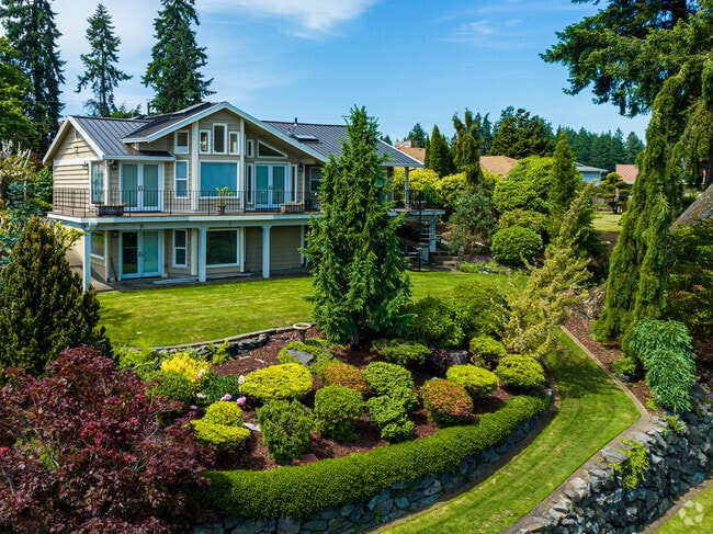 A lush garden surrounds this lakeside home.