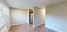 Located at 402 11th St N in Naples, FL, this one-bedroom, one-bathroom unit offers a compact and efficient floor plan across a single level. Warm-toned, wood-look flooring runs consistently throughout the space, creating a cohesive and inviting atmosphere. Neutral wall colors and white baseboards lend a clean, understated aesthetic to every room.

The open living and dining area provides a comfortable gathering space, with a ceiling fan overhead and natural light filtering in. The kitchen is well-appointed with rich dark wood cabinetry, light granite-style countertops, and a full suite of stainless steel appliances including a refrigerator, gas range, and built-in microwave — all seamlessly accessible from the main living area.

The bedroom is a quiet, functional retreat featuring its own ceiling fan, a window with blinds for natural light and privacy, a wall-unit air conditioner, and direct access to a closet. The bathroom is finished with classic white subway tile surrounding a full soaking tub and tub surround, complemented by a window that allows natural light into the space.

A hallway connects the rooms efficiently, making the most of the available footprint. This unit offers straightforward, practical living in a convenient Naples location.