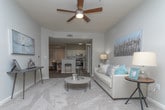 Located at 1717 Lavista Rd NE in Atlanta, Georgia, this well-appointed single-floor residence offers a thoughtfully designed layout with a neutral, contemporary aesthetic throughout. The living area is warm and inviting, featuring plush carpeting, soft gray walls, and natural light streaming through shuttered windows. A distinctive arched doorway leads to a dedicated sitting nook — an architectural highlight that adds character and charm to the main living space.

The kitchen is outfitted with crisp white cabinetry, granite-style countertops, stainless steel appliances including a gas range and refrigerator, and wood-look tile flooring, creating a clean and functional workspace. The space flows naturally into the surrounding living areas.

The bedrooms are comfortably sized, each with plush carpet, large windows with decorative curtains that invite ample natural light, and ceiling fans for year-round comfort. The primary bedroom features a ceiling fan with light fixture and views to the outdoors.

The bathrooms are finished with wood-look flooring and include tub-shower combinations with curtained enclosures, offering a clean and practical design. A hallway bathroom features a dedicated shower stall for added convenience.

Throughout the residence, a cohesive gray and neutral color palette, textured ceilings, and consistent flooring materials create a unified and comfortable living environment.