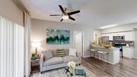 Located in Davie, FL, this 2-bedroom, 2-bathroom residence offers a well-designed single-level layout that makes efficient use of its space. Wood-style flooring runs throughout, lending warmth and continuity to each room.

The living room serves as the central gathering space, featuring a ceiling fan, textured ceilings, and sliding glass doors that open to a private patio, allowing natural light to flow in. A dining area sits adjacent, creating a seamless open flow between living and entertaining spaces.

The galley-style kitchen is well-appointed with white cabinetry, granite-style countertops, a tile backsplash, and a full suite of stainless steel appliances including a refrigerator, range, microwave, and dishwasher.

The spacious primary bedroom includes double closets, a ceiling fan, and a window with exterior views. The second bedroom is comparably comfortable, also featuring a ceiling fan and natural light. Both bathrooms follow a clean, consistent design with tub-shower combinations, wood-style flooring, and windows for ventilation. Each bathroom includes built-in shelving for added storage.

Overall, the residence presents a bright, neutral palette with practical finishes throughout, situated conveniently in Davie near College Court.