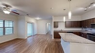 This contemporary 1130 square foot apartment in Austin, Texas offers a well-designed living space with three bedrooms and three bathrooms. The open-concept layout creates a seamless flow between rooms, enhancing the sense of spaciousness. The kitchen is a standout feature, boasting sleek wood cabinetry, granite countertops, and stainless steel appliances, including a built-in microwave and dishwasher.

Throughout the apartment, warm wood-look flooring adds a touch of elegance and continuity. Large windows in the bedrooms and living areas flood the space with natural light, while ceiling fans provide comfort and air circulation. The primary bedroom, measuring 170 square feet, offers ample space for relaxation.

The bathrooms are modern and functional, with one featuring a bathtub for added luxury. The in-unit laundry room comes equipped with a washer and dryer, adding convenience to daily life. The apartment also includes a closet for additional storage.

Located at 1200 Estancia Pkwy in Austin, this single-story apartment combines style and practicality, making it an ideal home for those seeking a contemporary living space in a desirable location.