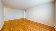 Located at 1475 Parkside Ave in Ewing, NJ, this one-bedroom, one-bathroom residence offers a well-organized single-floor layout that makes efficient use of its space. Warm hardwood flooring flows continuously throughout the living, dining, and bedroom areas, creating a cohesive and inviting atmosphere. The living room is generously sized, bathed in natural light from large windows fitted with blinds, and features a ceiling fan and baseboard heating for year-round comfort. A dedicated dining area connects seamlessly to the kitchen, which is equipped with warm wood cabinetry and a full suite of appliances, including a range. The bedroom is a comfortable size, offering a large double-door closet and a window with natural light. With three closets total spread across the unit, storage is well-represented throughout. Two hallways provide logical circulation between rooms. The bathroom is neatly appointed with tile flooring in a warm stone tone, a soaking tub, a toilet, and a vanity with white cabinetry topped by a lighted mirror. The clean, neutral color palette of white walls throughout the unit lends a bright, open feel to every room.