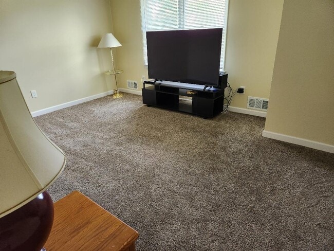 Living room with big screen TV and stand - 7226 Witmer Rd