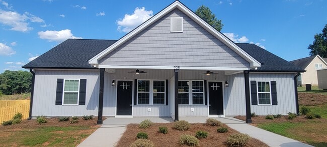 Front of duplex covered porch left side is unit A - 905 W Chestnut Ext