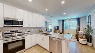 Located on Brittmoore Road in Houston, TX, this well-appointed 2-bedroom, 2-bathroom single-story residence offers a thoughtfully designed open-concept layout. The modern kitchen is a standout feature, showcasing white shaker cabinetry, granite countertops, a subway tile backsplash, a peninsula with additional prep space, and a full suite of stainless steel appliances including a range, microwave, dishwasher, and side-by-side refrigerator. Light wood-tone flooring flows seamlessly into the adjoining living room, which is brightened by large windows with natural light and fitted with a ceiling fan. The primary bedroom is a comfortable retreat with a ceiling fan, walk-in closet with wire shelving, and an en-suite bathroom featuring a granite-topped double vanity with white cabinetry and a well-lit mirror. The second bedroom also benefits from generous natural light through a large window and is served by a full bathroom complete with a tub/shower combo finished in marble-style tile and direct access to an additional closet. Both closets offer wire rack shelving for organized storage. The clean, neutral color palette and consistent finishes throughout lend the space a cohesive, contemporary ambiance.