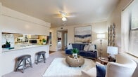 Located at 2601 W 12th St in Russellville, Arkansas, this single-floor, three-bedroom unit offers a well-organized and functional layout. The open-concept living and dining area connects seamlessly to the kitchen, creating a sociable and practical common space. The living room features plush carpeting, a ceiling fan with light fixture, a textured ceiling, and windows that admit generous natural light with views of the surrounding exterior. Neutral warm tones across the walls lend the space a cohesive, welcoming ambiance throughout.

The galley-style kitchen is efficiently designed with white cabinetry, white appliances including a range, refrigerator, and dishwasher, a double sink, and dark hardwood-style flooring. A breakfast bar with bar seating connects the kitchen to the living area, enhancing the open feel.

The primary bedroom offers carpeted flooring, a window for natural light, and closet storage. The two additional bedrooms are similarly appointed with carpet, windows, closet space, and neutral walls, providing comfortable and versatile accommodations. Each bedroom benefits from a quiet, private atmosphere.

A hallway connects the bedrooms to the main living areas, with closets providing additional storage throughout the unit. The overall design is practical and accessible, suited for a variety of living arrangements.