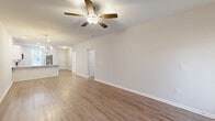 Located at 106 Copper Ridge Rd in Evans, GA, this single-story, 2-bedroom, 3-bathroom home offers a well-designed layout with modern finishes throughout. The entrance opens to a hallway leading into a bright, open-concept living, dining, and kitchen area. The living room features warm hardwood-style flooring, a ceiling fan, a fireplace, and a chandelier accent near the dining space. The kitchen is outfitted with white shaker-style cabinetry, granite countertops, a subway tile backsplash, and stainless steel appliances including a range with over-the-range microwave. The spacious primary bedroom includes a tray ceiling with crown molding, a ceiling fan, hardwood-style flooring, and direct access to an en-suite bathroom featuring a walk-in shower with glass doors, a soaking tub, tile flooring, and a walk-in closet. The second bedroom offers natural light through a window with blinds and matching hardwood-style flooring. Three full bathrooms, four closets, a dedicated laundry room, and an attached garage with an automatic opener complete this well-appointed home. Neutral tones and consistent flooring throughout create a cohesive, move-in-ready atmosphere.