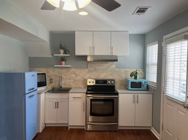 The kitchen space has a split oven and a tabletop dishwasher. - 7837 Heaton Way Townhome