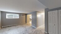 This single-floor, 3-bedroom, 2-bathroom unit at 314 E 24th St in Chester, PA offers a practical and well-organized layout. The living room features neutral gray walls, tile flooring, and a window that allows natural light to filter in, with a baseboard heating unit ensuring year-round comfort. An open sightline connects the living area to the kitchen, which is outfitted with white cabinetry, stainless steel appliances including a refrigerator, electric range, and hood vent, complemented by tile flooring and a window above the sink. The spacious primary bedroom offers generous square footage, carpet flooring, multiple windows for ample natural light, and baseboard heating. The two additional bedrooms are also carpeted, each with windows and baseboard heaters, providing comfortable and functional spaces. Closet storage is available, with at least one bedroom featuring a built-in closet with double doors. The two bathrooms include a clean, white tub-shower surround. Throughout the unit, consistent gray-toned walls and crisp white trim create a cohesive, modern aesthetic, while tile and carpet flooring distinguish the common areas from the private spaces.