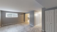 This single-floor, 3-bedroom, 2-bathroom unit at 314 E 24th St in Chester, PA offers a practical and well-organized layout. The living room features neutral gray walls, tile flooring, and a window that allows natural light to filter in, with a baseboard heating unit ensuring year-round comfort. An open sightline connects the living area to the kitchen, which is outfitted with white cabinetry, stainless steel appliances including a refrigerator, electric range, and hood vent, complemented by tile flooring and a window above the sink. The spacious primary bedroom offers generous square footage, carpet flooring, multiple windows for ample natural light, and baseboard heating. The two additional bedrooms are also carpeted, each with windows and baseboard heaters, providing comfortable and functional spaces. Closet storage is available, with at least one bedroom featuring a built-in closet with double doors. The two bathrooms include a clean, white tub-shower surround. Throughout the unit, consistent gray-toned walls and crisp white trim create a cohesive, modern aesthetic, while tile and carpet flooring distinguish the common areas from the private spaces.