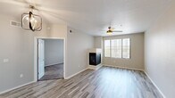 Located at 17950 North 68th Street in Phoenix, AZ, this one-bedroom, one-bathroom residence offers a well-designed single-floor layout. The open-concept living room and kitchen area serves as the heart of the home, featuring light wood-look flooring, a textured ceiling, and a ceiling fan that keeps the space comfortable. A sleek built-in fireplace anchors the living area, while a large window with vertical blinds fills the room with natural light and provides views of the surrounding neighborhood.

The kitchen is outfitted with white shaker-style cabinetry, light quartz countertops, a subway tile backsplash, and a full suite of stainless steel appliances including a refrigerator, range, and microwave. A deep stainless steel sink completes this functional and stylish cooking space.

The bedroom is a comfortable retreat, carpeted for warmth and equipped with its own ceiling fan and a generously sized window. A dedicated closet provides ample storage. The bathroom features a full soaking tub and shower combination with clean white tile surround and brushed nickel fixtures. A hallway connects the rooms, contributing to an efficient and cohesive floor plan throughout the residence.