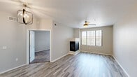 Located at 17950 North 68th Street in Phoenix, AZ, this one-bedroom, one-bathroom residence offers a well-designed single-floor layout. The open-concept living room and kitchen area serves as the heart of the home, featuring light wood-look flooring, a textured ceiling, and a ceiling fan that keeps the space comfortable. A sleek built-in fireplace anchors the living area, while a large window with vertical blinds fills the room with natural light and provides views of the surrounding neighborhood.

The kitchen is outfitted with white shaker-style cabinetry, light quartz countertops, a subway tile backsplash, and a full suite of stainless steel appliances including a refrigerator, range, and microwave. A deep stainless steel sink completes this functional and stylish cooking space.

The bedroom is a comfortable retreat, carpeted for warmth and equipped with its own ceiling fan and a generously sized window. A dedicated closet provides ample storage. The bathroom features a full soaking tub and shower combination with clean white tile surround and brushed nickel fixtures. A hallway connects the rooms, contributing to an efficient and cohesive floor plan throughout the residence.
