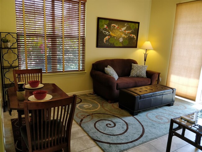 Living + Dining area now with tile and area rugs, not as yellow looking in real life - 170 Kuli Puu St