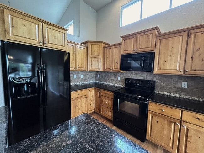 Building Photo - $500 Off First Month Of Rent! Modern 3BR Townhome with Fenced Yard & Garage