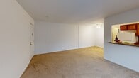 Located at 4608 Haverford Pl in Wilmington, Delaware, this one-bedroom, one-bathroom unit offers a practical and comfortable single-floor layout. The open-concept living and kitchen area forms the heart of the home, with soft neutral carpeting in the living space and a pass-through counter connecting it to the kitchen. The kitchen is well-equipped with warm wood cabinetry, a mosaic tile backsplash, granite-style countertops, white appliances including a refrigerator, electric range, and microwave, as well as tile flooring and a window that brings in natural light. A wall-mounted air conditioning unit and baseboard heating serve the living area, which also benefits from natural light through a window fitted with blinds. The generously sized bedroom features plush carpeting, a ceiling fan, a large window, and a double-door closet offering ample storage. The bathroom is finished with stone-look tile flooring and a full tub and shower combination framed by striking marble-patterned wall tile. A hallway connects the rooms efficiently, completing this well-organized and move-in ready layout.