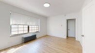 Located at 1430 Monroe Ave in Rochester, NY, this single-floor unit offers three bedrooms, one bathroom, a kitchen, and a hallway within a compact but efficiently arranged footprint. The layout is thoughtfully organized to maximize the available space across all rooms.

Light wood laminate flooring runs consistently throughout the unit, creating a cohesive and bright aesthetic. The walls are finished in crisp white throughout, contributing to an open, clean feel. Cast-iron radiators are present in multiple rooms, serving as both functional heating elements and subtle nods to the building's older architectural character.

The spacious primary bedroom receives natural light through large, multi-pane windows fitted with horizontal blinds, and features a dedicated closet with a built-in shelf rod. The additional bedrooms are similarly bright and well-proportioned. The galley-style kitchen is lined with white cabinetry on both sides, offering ample storage, and is equipped with a stainless steel refrigerator, a gas range, a double sink with a modern faucet, and a tile backsplash. The bathroom includes a full tub-shower combination with classic white subway tile surround. A connecting hallway ties the rooms together, completing this straightforward and functional single-floor layout.