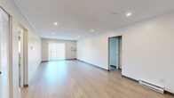 Located at 349 North Pearl Street in Brockton, MA, this 2-bedroom, 2-bathroom residence offers a well-organized single-floor layout designed for comfortable everyday living. The spacious living room is a standout feature, showcasing light-toned hardwood-style flooring, recessed ceiling lighting, and a large sliding glass door with vertical blinds that invites natural light and provides outdoor access. A wall-mounted air conditioning unit and baseboard heating ensure year-round comfort throughout the living area. The kitchen is thoughtfully appointed with white shaker-style cabinetry, marble-look countertops, stainless steel appliances including a dishwasher and range, and a full-size refrigerator, all set atop matching light-wood flooring. Both bedrooms are carpeted and feature built-in double-door closets, neutral-toned walls, and individual climate control units. The primary bedroom offers generous proportions with a window for natural light. The two bathrooms are clean and functional — one includes a full tub-shower combo with white subway tile surround and chrome fixtures, while the other features a white vanity with under-cabinet storage and a mirrored medicine cabinet. Hallways connect the rooms efficiently, completing this practical and well-finished layout.