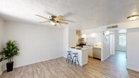 Located at 6320 N 16th St in Phoenix, AZ, this single-story, one-bedroom, one-bathroom unit offers a thoughtfully designed layout that maximizes its cozy footprint. Light wood-look flooring runs throughout the space, creating a cohesive and modern aesthetic.

The kitchen is a standout feature, equipped with stainless steel appliances including a gas range, dishwasher, and refrigerator. White cabinetry lines the walls with a classic subway tile backsplash, while a peninsula with a white countertop and bar seating provides a convenient dining and prep area. A ceiling fan overhead adds comfort to the adjacent living area, which benefits from natural light and clean white walls.

The bedroom is a comfortable, well-proportioned retreat featuring a ceiling fan with a light fixture, a window for natural light, and a sliding-door closet offering ample storage. The textured ceiling adds subtle character throughout.

The bathroom is clean and functional, showcasing large-format tile surrounds in a neutral tone within a tub-shower combination. Wood-look flooring continues here, complementing the white vanity and fixtures for a streamlined, unified look.

Overall, this unit presents a clean, modern interior with consistent finishes, making it a practical and attractive living space in central Phoenix.