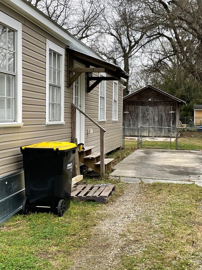 Side covered entry. Fenced in backyard with storage - 161 Eighth Street Dr