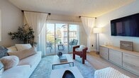 This single-story, 2-bedroom, 1-bathroom residence in Vallejo, California offers a thoughtfully designed layout with a comfortable flow throughout. Light wood-style flooring runs through the main living areas, connecting each space cohesively. A welcoming entry hallway leads toward the open living and dining area, where large sliding glass doors flood the room with natural light and provide direct access to a private balcony overlooking the surrounding neighborhood.

The living room offers ample space for seating and relaxation, while the adjacent dining area accommodates a four-person table and is complemented by a ceiling fan overhead. The kitchen features rich dark wood cabinetry, granite-style countertops, and black appliances including a refrigerator, range, and dishwasher, with a window that brings in additional natural light.

Both bedrooms are generously sized, each featuring large closets with sliding doors and windows that invite natural light. The textured ceilings are consistent throughout, and neutral wall tones create a calm, versatile backdrop. The unit's efficient layout maximizes usable space while maintaining a comfortable and livable ambiance throughout.