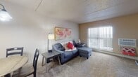 Located at 170 Ruth St N in Saint Paul, Minnesota, this single-floor unit offers a straightforward and functional layout well-suited for comfortable everyday living. The living room is carpeted and receives natural light through a large window fitted with vertical blinds, creating a bright and inviting atmosphere. The space comfortably accommodates a sectional sofa and side table, with wall art adding a warm, decorative touch.

The kitchen features white cabinetry with oak-trimmed accents, butcher block-style countertops, and tile flooring. It is equipped with a coil-burner electric range, dishwasher, and includes counter space for small appliances such as a microwave and coffee maker.

The unit includes two bedrooms, both carpeted and naturally lit through windows with vertical blinds. Each room offers a calm, restful environment with neutral wall tones and baseboard heating. One bedroom features a rustic wood-panel headboard, while the other is accented by a bold botanical wall piece that adds visual interest.

The bathroom includes a wood-framed vanity mirror, a butcher block-style countertop with an undermount sink, under-sink cabinetry, and hardwood flooring, all complemented by a well-lit vanity fixture. The overall design of the unit is practical and cohesive, with consistent warm neutral tones throughout.