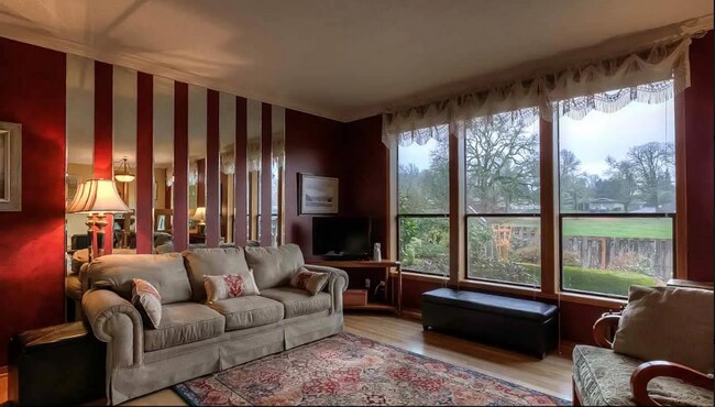 Building Photo - 4bd/3ba HUGE Home w/Hardwood Floors, Russian Fireplace, 2-Car Garage & Fenced Back Yard!