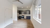 Located at 2000 North 2nd Street in Philadelphia's vibrant North Philadelphia neighborhood, this one-bedroom, one-bathroom unit offers a thoughtfully designed layout across a single floor. The open living and kitchen area is anchored by wood-look plank flooring and crisp white walls, with recessed lighting and a ceiling fan enhancing the bright, clean atmosphere. Large windows allow natural light to fill the space throughout the day.

The kitchen is a standout feature, showcasing sleek dark gray cabinetry, a textured tile backsplash, and light countertops that create a contemporary contrast. A full suite of stainless steel appliances — including a refrigerator, range, microwave, and dishwasher — along with open upper shelving, make this kitchen as functional as it is stylish.

The bedroom offers a comfortable, well-proportioned layout with a built-in closet, wood-look flooring, and a window providing natural light. The clean white walls contribute to a calm, neutral ambiance. The bathroom features a full soaking tub with a tiled surround, maintaining the unit's clean, modern aesthetic.

A dedicated laundry area houses a stacked washer and dryer unit, adding everyday convenience. This well-appointed space combines modern design with practical functionality in a compact, efficient footprint.