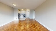 Located at 321 Sherbourne Street in Toronto's vibrant St. James Town neighbourhood, this one-bedroom, one-bathroom unit offers a well-organized layout across a single floor. Distinctive parquet hardwood flooring runs throughout the main living areas, lending a warm, classic character to the space.

The open-concept living and dining area is generously proportioned, anchored by large windows that frame city views and invite abundant natural light. Baseboard heating units line the perimeter beneath the windows, ensuring year-round comfort. A private balcony extends the living space outdoors, offering an additional retreat with urban views.

The kitchen is efficiently designed with white cabinetry, a subway tile backsplash, tile flooring, stainless steel appliances including a full-size refrigerator and dishwasher, and a granite-style countertop with an integrated sink — providing a clean, modern aesthetic.

The bedroom is a comfortable size, featuring the same parquet flooring, a large window with city views, and a sliding-door closet for convenient storage. Three closets in total are distributed throughout the unit, offering practical storage solutions. The bathroom is finished with a full soaking tub surrounded by crisp white subway tile. A dedicated entrance and hallway complete the thoughtful floor plan.