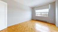 Located at 495 Errol Rd W in Sarnia, Ontario, this well-appointed one-bedroom, one-bathroom unit offers a comfortable and functional layout across a single floor. Warm parquet wood flooring flows throughout the living spaces, adding a timeless character to every room.

The open living and dining area is bright and airy, benefiting from large windows and a sliding door that leads to a private balcony with pleasant outdoor views of the surrounding landscape. The kitchen is thoughtfully updated with white shaker-style cabinetry, neutral stone-look countertops, a tasteful tile backsplash, and full appliances including an electric range and built-in microwave — all finished in a clean, cohesive palette.

The generously sized bedroom features a double closet with bifold doors and a window that frames a tranquil, tree-lined view. Baseboard heating is present throughout, ensuring year-round comfort. The bathroom is finished with neutral tile flooring, a white vanity with storage, and a full soaker tub with shower surround.

A dedicated entrance and additional storage add to the practicality of this unit. The overall ambiance is clean, bright, and move-in ready, making it an ideal space for those seeking comfortable, low-maintenance living in Sarnia.