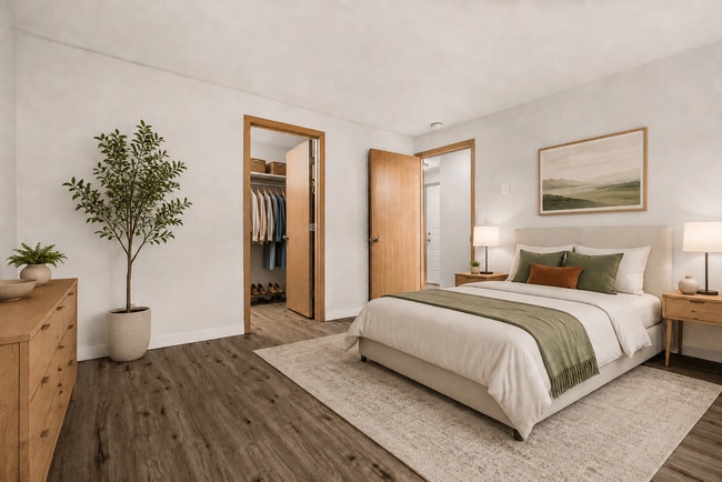 Unwind in a spacious bedroom featuring a convenient walk-in closet. - Stonegate Apartments