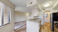 Located at 99 Antelope Way in Worthington, Ohio, this single-floor residence offers a clean, modern aesthetic throughout its thoughtfully designed layout. The open-concept living and dining area is bright and inviting, featuring warm hardwood-style flooring, neutral walls, and a large sliding glass door that opens to a private balcony overlooking a natural wooded backdrop, allowing for generous natural light and serene outdoor views. A secondary window further enhances the sense of openness in the living space.

The kitchen is efficiently designed with white shaker-style cabinetry, granite-look countertops, a peninsula with an undermount sink, and stainless steel appliances including a range and refrigerator. The layout connects seamlessly to the main living area, making the space ideal for everyday functionality.

The bedroom is carpeted and comfortably sized, featuring a window with views of the surrounding trees, providing a quiet and restful environment. The bathroom is well-appointed with white cabinetry, a single-sink vanity with a solid-surface countertop, a large mirror, bright vanity lighting, and a tub-shower combination. Hardwood-style flooring continues through the bathroom, maintaining a consistent, cohesive design. Overall, the unit presents a fresh, updated feel throughout.