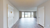Located at 5840 Lake Resort Terrace in Chattanooga, Tennessee, this single-floor residence offers a well-designed layout with a variety of functional spaces. The expansive living area is one of the home's standout features, showcasing durable wood-style flooring, neutral wall tones, and a large sliding glass door that floods the room with natural light and frames stunning views of the adjacent lake — a truly scenic focal point of the space.

The galley-style kitchen is thoughtfully equipped with white cabinetry, dark granite-style countertops, stainless steel appliances including a dishwasher and range, and wood-style flooring. A chandelier-lit passage connects the kitchen to the adjoining dining or living area, enhancing the overall flow.

The bedrooms feature plush carpeting, natural light from windows, and built-in closets with bifold doors, providing ample storage. The bathrooms are well-appointed with wood-style flooring, dark countertops, white cabinetry, and tiled shower and tub surrounds. One bathroom features an extended vanity countertop, adding extra utility.

Overall, the space presents a clean, neutral palette with a comfortable, functional layout complemented by beautiful lakeside surroundings.
