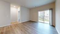 Located at 101 NW Mock Ave in Blue Springs, MO, this well-appointed 2-bedroom, 2-bathroom residence offers a thoughtfully designed single-level layout. The open-concept kitchen and living area serves as the heart of the home, showcasing white shaker cabinetry, granite countertops, a subway tile backsplash, and a full suite of stainless steel appliances. A central kitchen island with an undermount sink and pendant lighting adds both functionality and style. Light-toned luxury vinyl plank flooring flows throughout the main living areas, complemented by neutral walls that create a bright, clean aesthetic. Sliding glass doors open to a private balcony, bringing in natural light and outdoor views. The generously sized primary bedroom features plush carpeting and access to a dedicated bathroom with granite countertops, white cabinetry, and a spacious walk-in closet outfitted with wire shelving. The second bedroom also includes carpeted flooring and its own walk-in closet with built-in shelving. Additional highlights include a dedicated laundry room, a pantry, four closets total, and a utility room, providing ample storage throughout. This residence combines modern finishes with practical design for comfortable everyday living.