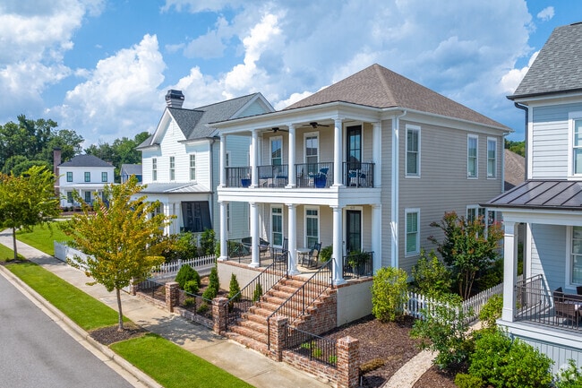 Two-story porches catch the breeze on modern Charleston-style homes in Hammonds Ferry.
