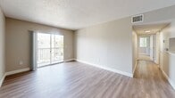 Located at 741 Providence Trace Cir in Brandon, FL, this well-appointed 2-bedroom, 2-bathroom residence offers a thoughtfully designed single-floor layout. The open living area features durable wood-look plank flooring, neutral warm-toned walls, and a textured ceiling, creating a bright and welcoming atmosphere. Sliding glass doors lead to a private balcony, allowing natural light to fill the space. The kitchen is outfitted with white cabinetry, light countertops, stainless steel appliances, and a pass-through breakfast bar that connects seamlessly to the dining and living areas. A dedicated laundry area adds everyday convenience. Both bedrooms are carpeted for comfort and feature closet storage — the primary bedroom includes a spacious walk-in closet with wire shelving and a ceiling fan with a natural outdoor view through vertical-blind windows. The second bedroom also includes a reach-in closet. Each of the two bathrooms features wood-look flooring, a tub-shower combination with tile surround, and clean white fixtures. One bathroom includes a vanity with white cabinetry and light countertops. The overall design is clean, functional, and move-in ready, ideal for comfortable everyday living in the Brandon, FL area.