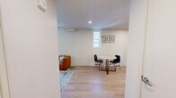 Located on an upper floor at 2024 Jane St in Pittsburgh's South Side, this efficient one-bedroom, one-bathroom unit offers a thoughtfully designed layout with modern finishes throughout. Light hardwood flooring runs continuously across the living areas, creating a cohesive and clean aesthetic.

The living room is bright and open, featuring large windows that frame panoramic views of the Pittsburgh cityscape, flooding the space with natural light. A compact dining area connects seamlessly to the living space, ideal for everyday use.

The kitchen is outfitted with wood-toned cabinetry extending to the ceiling, white quartz countertops, a tiled backsplash, and a full suite of stainless steel appliances including a refrigerator, electric range, over-the-range microwave, and dishwasher — all under recessed lighting.

The bedroom is a calm, minimalist retreat with light-toned walls, light wood flooring, and a large window offering natural light and outdoor views. In-unit laundry adds everyday convenience.

The bathroom features a wood-toned vanity with a white countertop, light hardwood-style flooring, and a walk-in shower enclosed by a sleek frameless sliding glass door with matte black hardware. The overall design is clean and contemporary throughout.