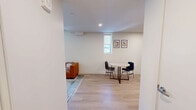 Located on an upper floor at 2024 Jane St in Pittsburgh's South Side, this efficient one-bedroom, one-bathroom unit offers a thoughtfully designed layout with modern finishes throughout. Light hardwood flooring runs continuously across the living areas, creating a cohesive and clean aesthetic.

The living room is bright and open, featuring large windows that frame panoramic views of the Pittsburgh cityscape, flooding the space with natural light. A compact dining area connects seamlessly to the living space, ideal for everyday use.

The kitchen is outfitted with wood-toned cabinetry extending to the ceiling, white quartz countertops, a tiled backsplash, and a full suite of stainless steel appliances including a refrigerator, electric range, over-the-range microwave, and dishwasher — all under recessed lighting.

The bedroom is a calm, minimalist retreat with light-toned walls, light wood flooring, and a large window offering natural light and outdoor views. In-unit laundry adds everyday convenience.

The bathroom features a wood-toned vanity with a white countertop, light hardwood-style flooring, and a walk-in shower enclosed by a sleek frameless sliding glass door with matte black hardware. The overall design is clean and contemporary throughout.