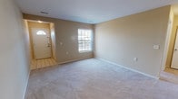 This single-floor, 2-bedroom, 2-bathroom residence offers a thoughtfully arranged layout designed for comfortable, everyday living. The entryway features tile flooring and leads into a generously sized living area finished with plush wall-to-wall carpeting and warm neutral-toned walls. A large window allows natural light to fill the space, creating a bright and welcoming atmosphere.

The kitchen is equipped with stainless steel appliances, including a gas range and refrigerator, complemented by rich wood cabinetry and granite-style countertops. Light hardwood-style flooring ties the kitchen and adjoining dining area together seamlessly.

Both bedrooms are carpeted and share the same neutral color palette, with each room featuring windows that provide natural light and outdoor views. The rooms offer ample wall space suitable for a variety of furniture arrangements.

The two bathrooms are well-appointed with granite-style countertops, wood cabinetry, and updated fixtures. One bathroom features a walk-in shower with a sliding glass door, while the second includes a full tub-shower combination with white tile surround.

Overall, the space maintains a clean, functional aesthetic with consistent finishes throughout, making it a practical and comfortable residence.